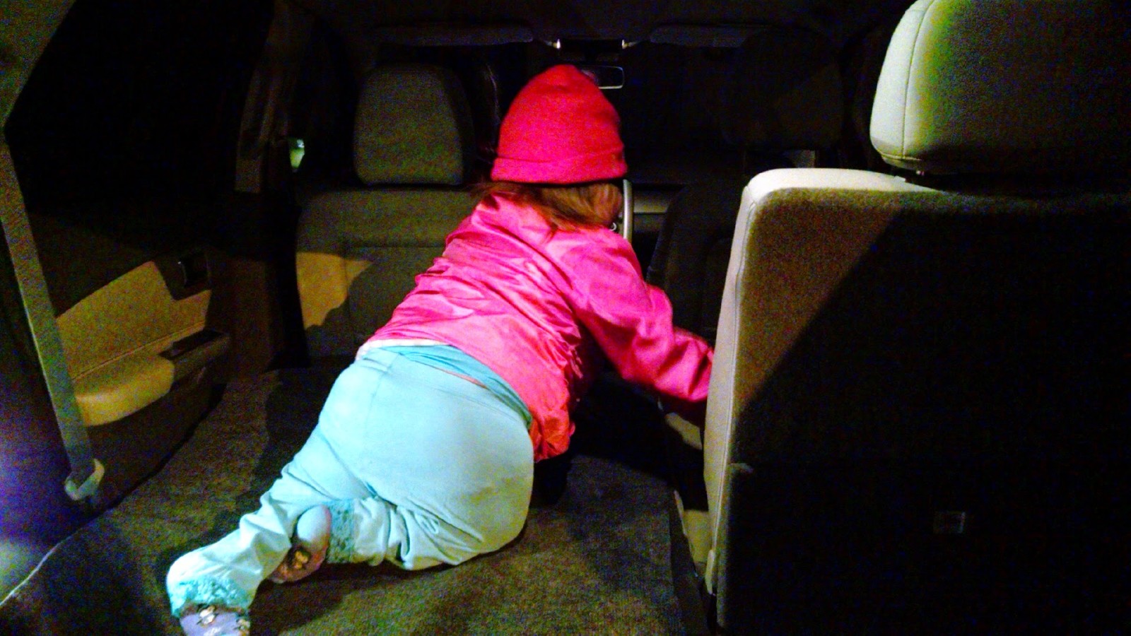 Climbing into her car seat